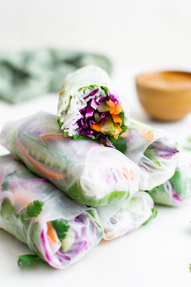 spring roll wrapper with noodles, cabbage, rice, lettuce, and cucumber