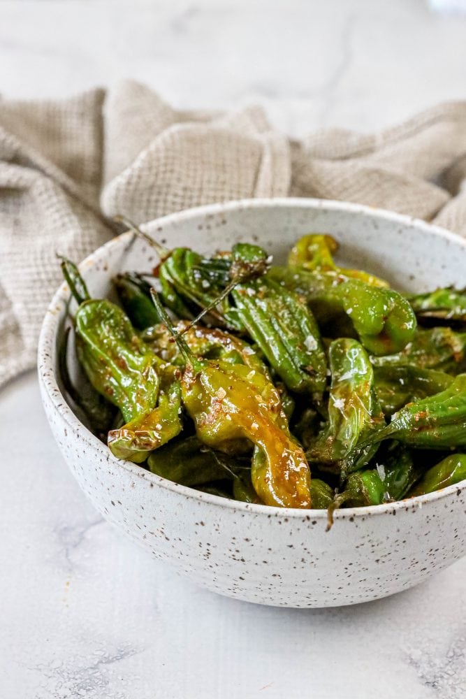 shishito peppers in a bowl on a table