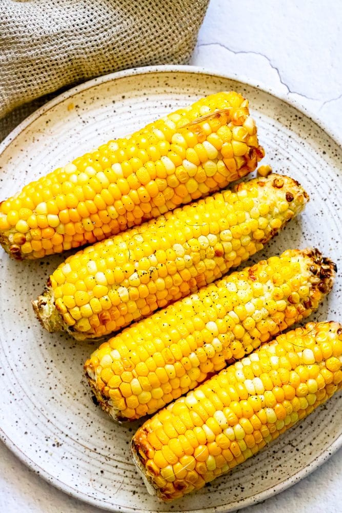 roasted cobs corn on a plate