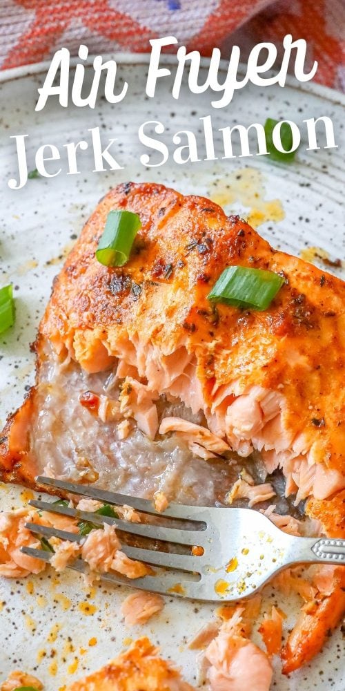 salmon with spices and green onions in it with a fork on it