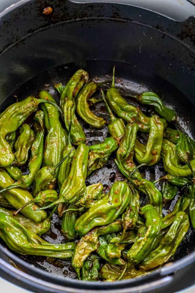 picture of shishito peppers in an air fryer basket