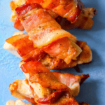 Bacon wrapped chicken skewers on a blue plate, the Best Bacon Wrapped Chicken Bites Recipe.