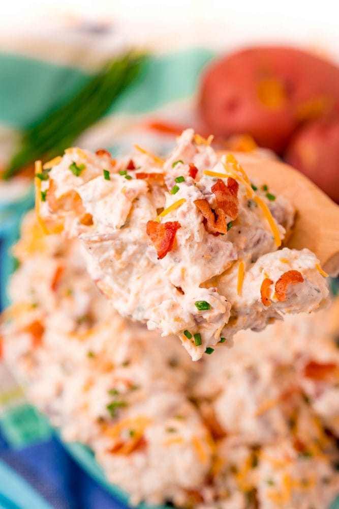 creamy ranch potato salad on wooden spoon