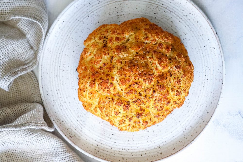 whole roasted cauliflower head on a plate