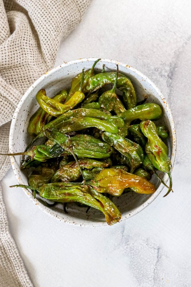 shishito peppers in a bowl on a table