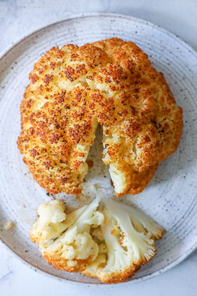 whole roasted cauliflower head on a plate