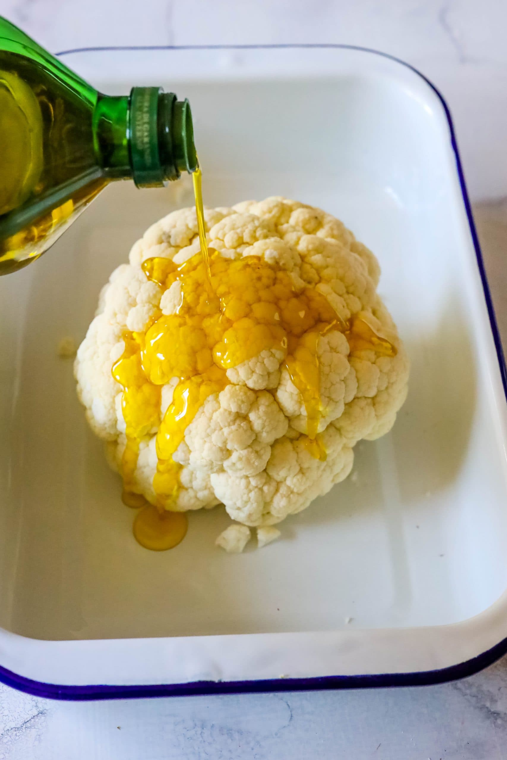A keto-friendly version of easy roasted cauliflower where the vegetable is drizzled with olive oil.