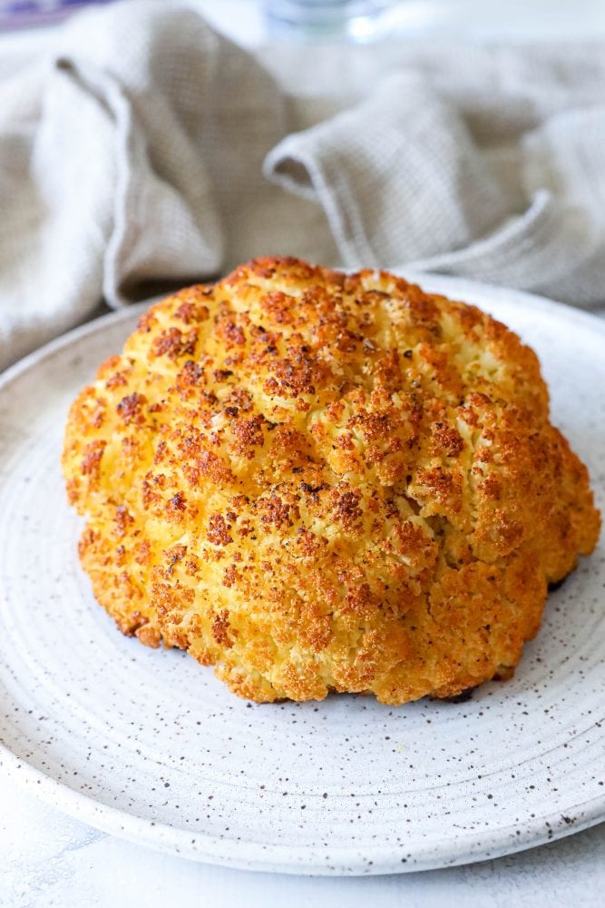 whole roasted cauliflower head on a plate