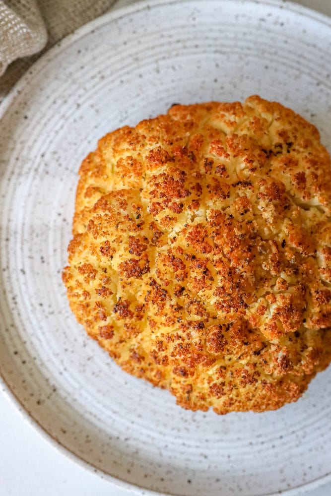 picture of whole roasted cauliflower head on a plate