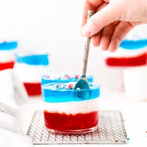 A Fourth of July-themed jello cup recipe featuring red, white, and blue layers.