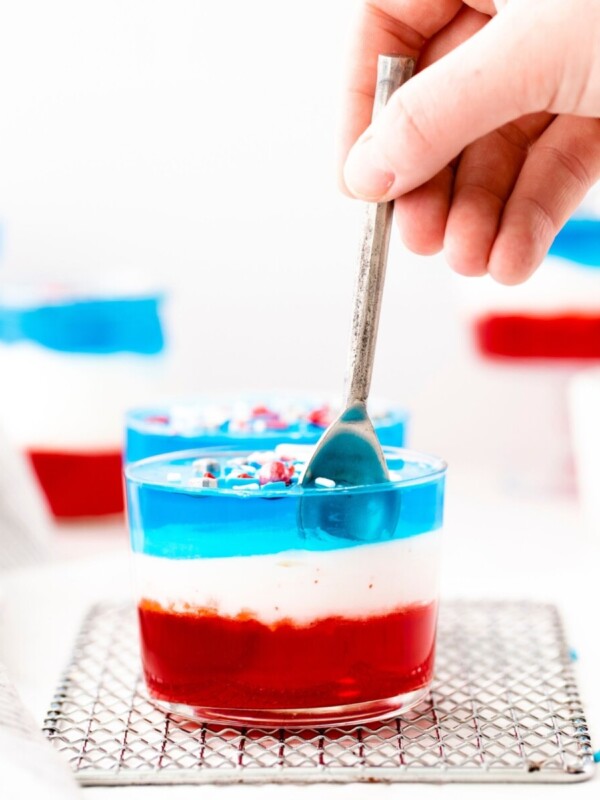 A Fourth of July-themed jello cup recipe featuring red, white, and blue layers.