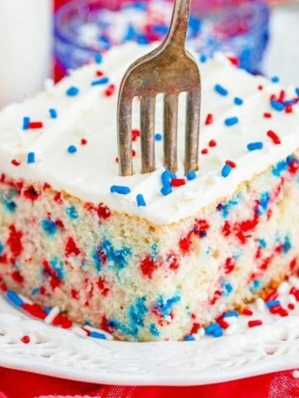 funfetti 4th of july cake iced with buttercream icing and a fork digging in