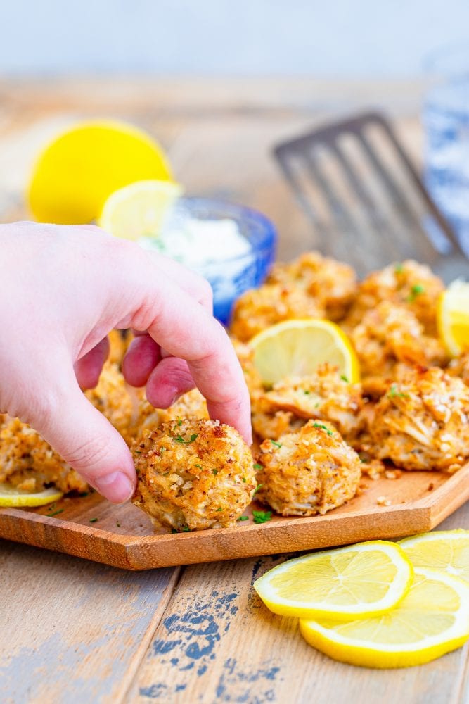 picture of a hand holding a crab cake