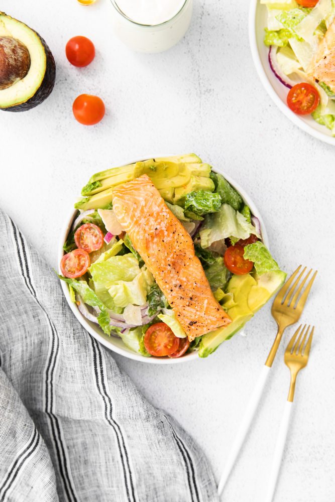 salad, tomatoes, avocado, red onion, cheese, and salmon