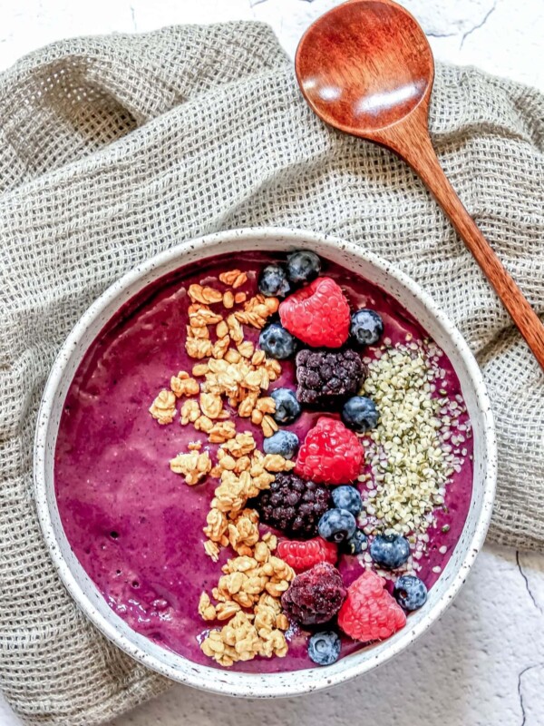 A bowl filled with granola and berries.