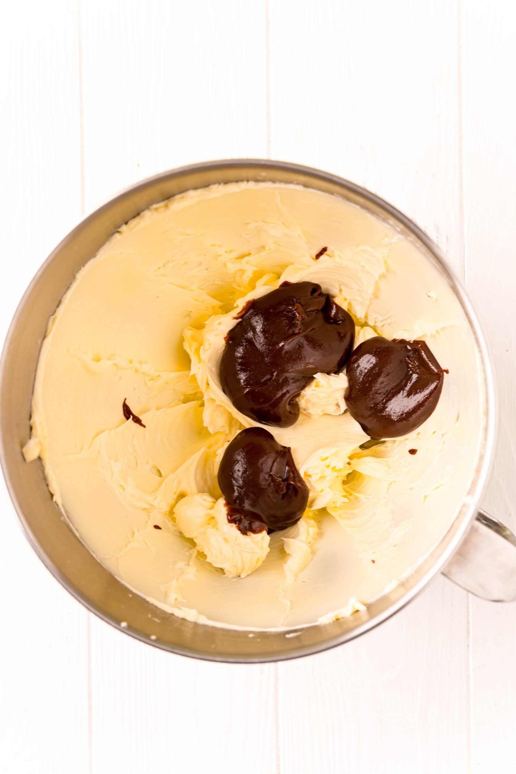 A delicious chocolate ice cream on a wooden table with the best chocolate frosting recipe.