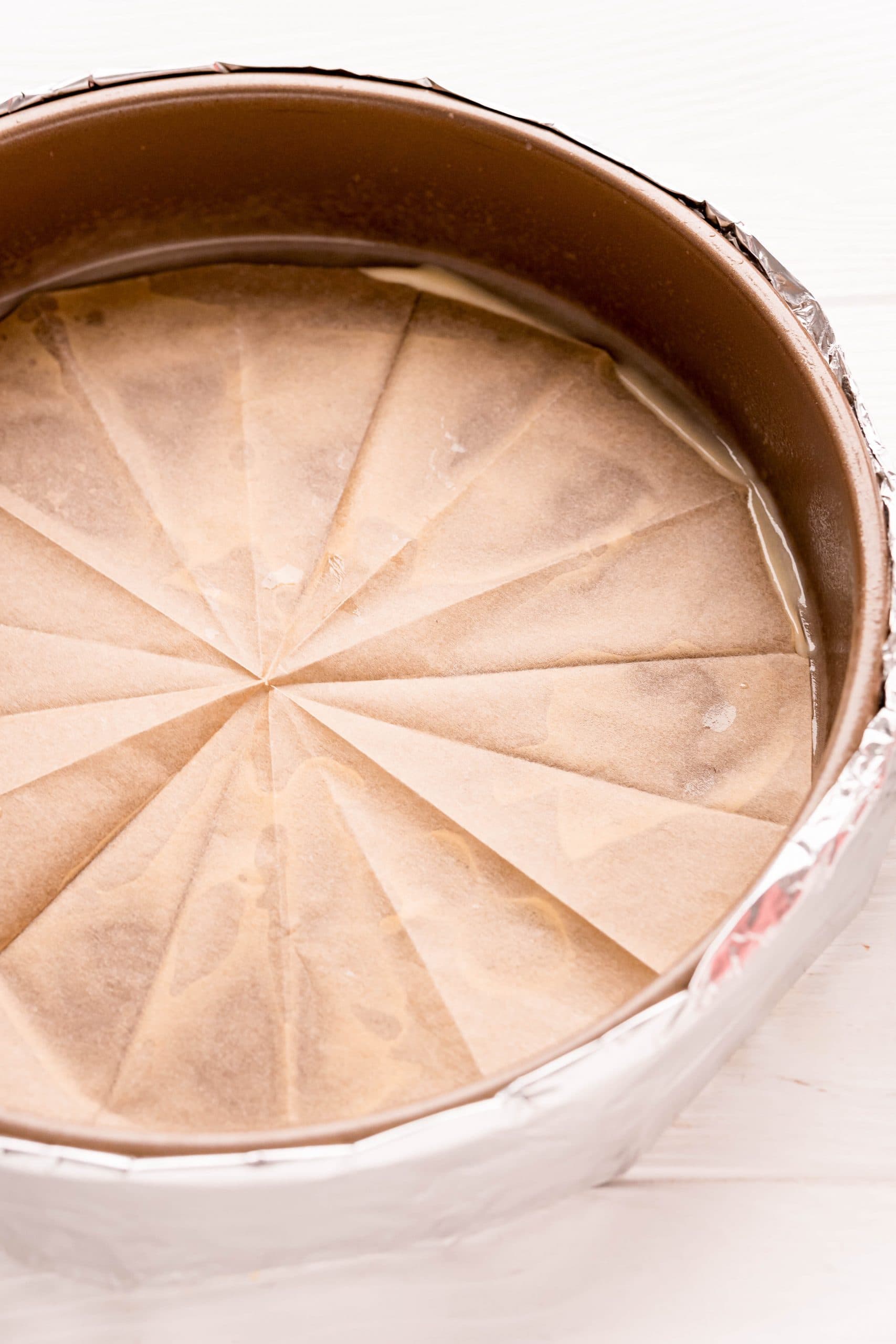 A pie crust is sitting in a pan on a table, ready to be filled with The Best Easy Chocolate Cake Recipe.