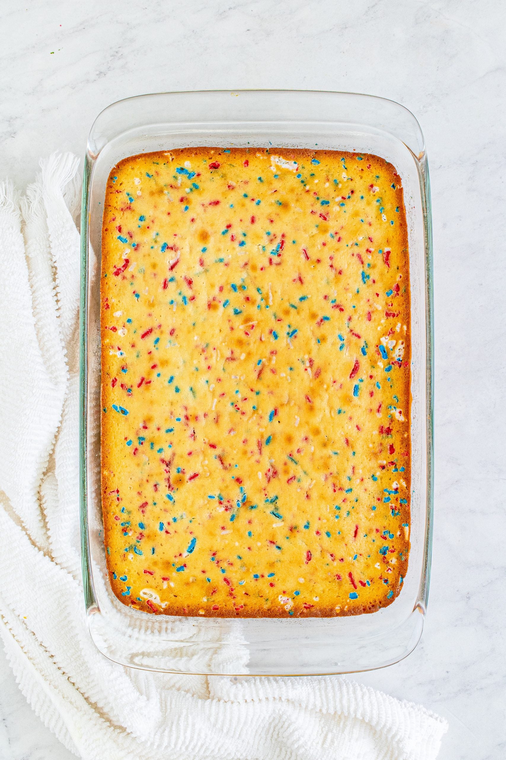 baked red white and blue funfetti cake in a pan