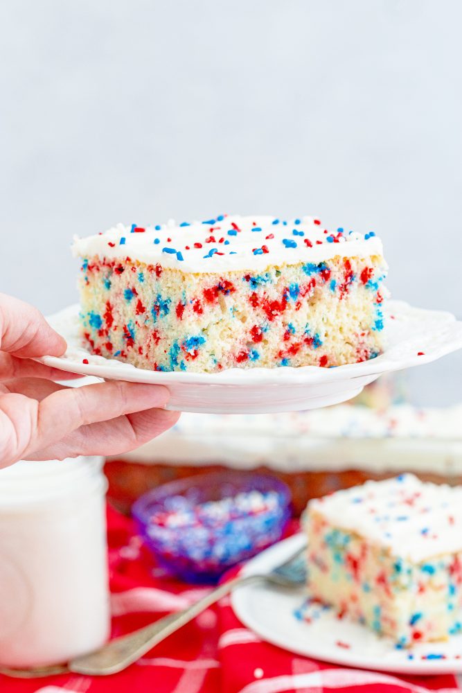 sheet cake on a plate with sprinkles and icing