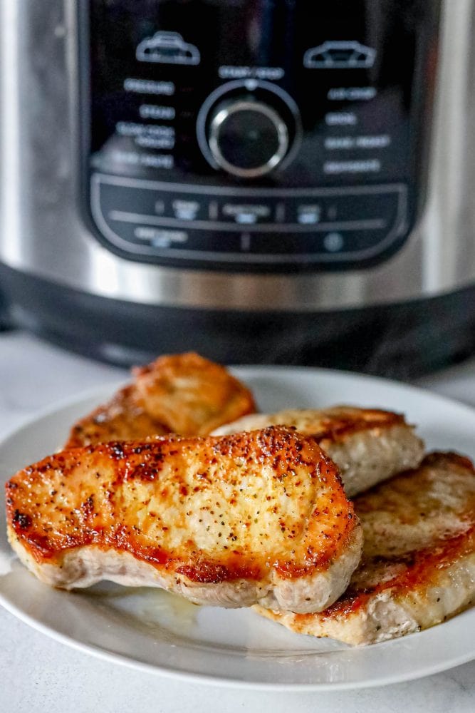 picture of pork chops next to air fryer 