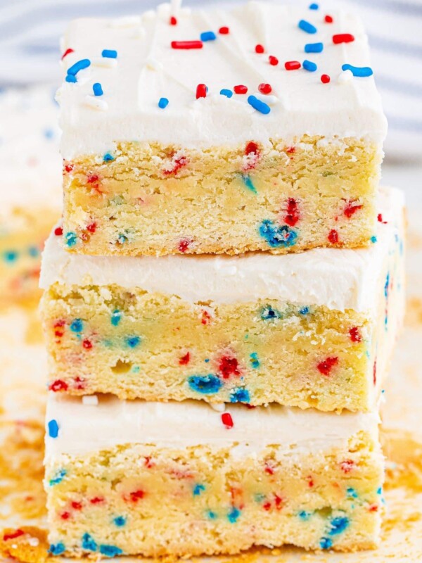 A stack of patriotic funfetti sugar cookie bars with sprinkles on top.