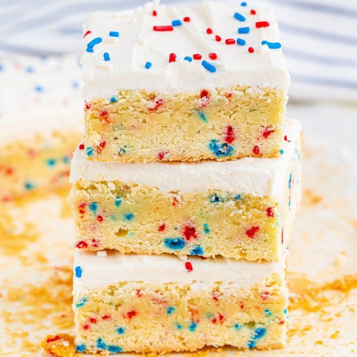 A stack of patriotic 4th of July funfetti sugar cookie bars with sprinkles on top.