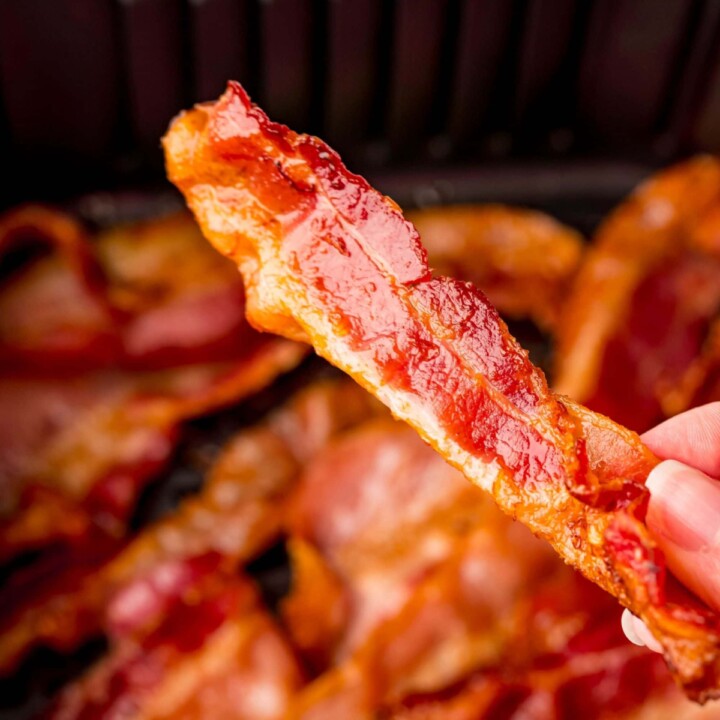 picture of hand holding a piece of air fried bacon