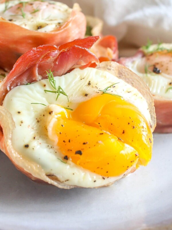A plate of keto baked egg cups with dill on it.