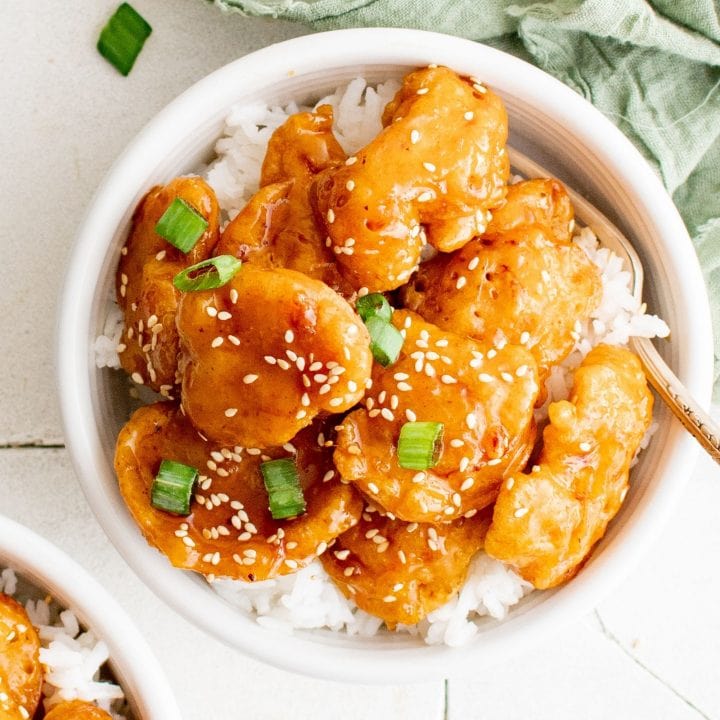picture of sesame chicken on a bowl of rice
