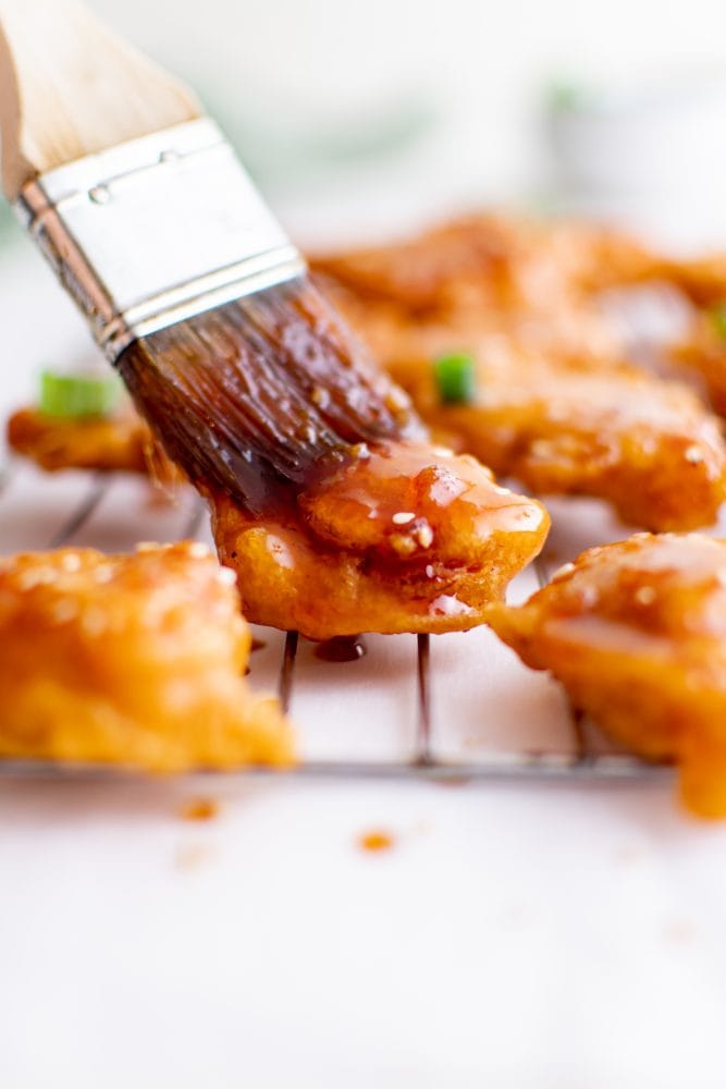 picture of sesame chicken on a bowl of rice