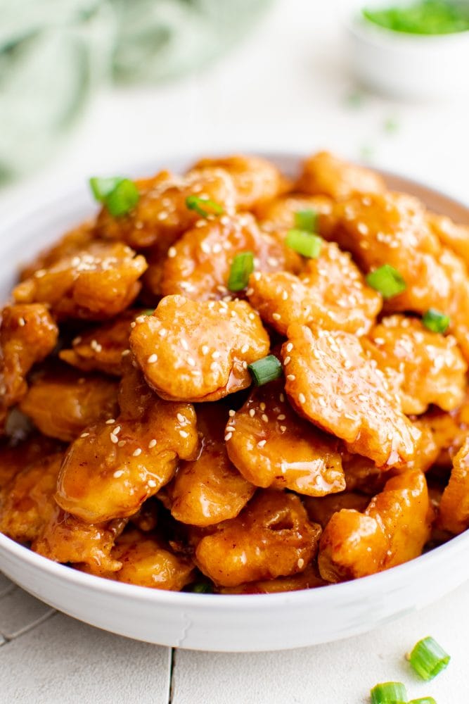 picture of sesame chicken in a bowl over rice