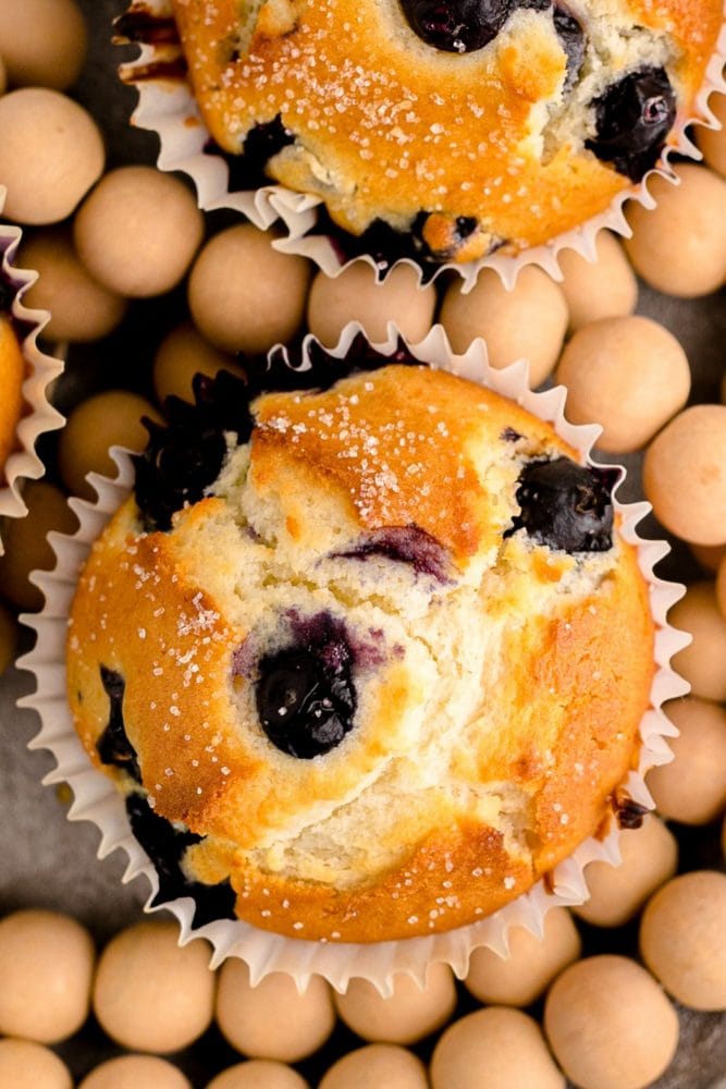 two muffins with blueberries baked into it and sugar on top