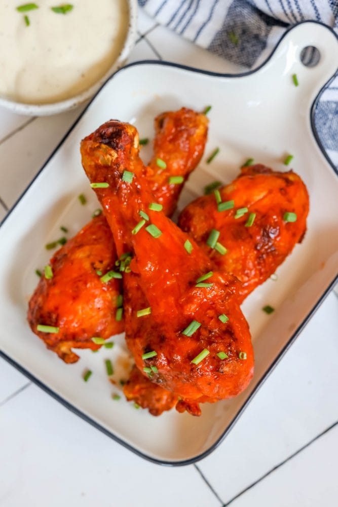 chicken drumsticks with red buffalo sauce on them