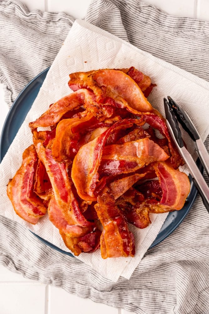 picture of bacon sitting on a plate with paper towels on it
