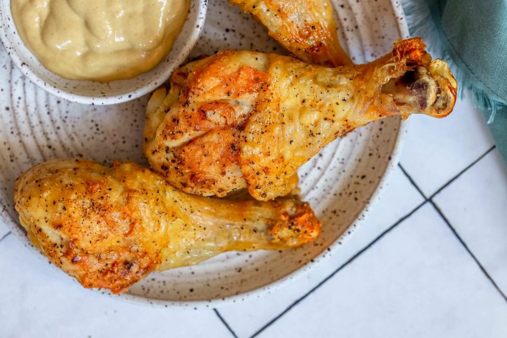 picture of chicken drumsticks on a white plate