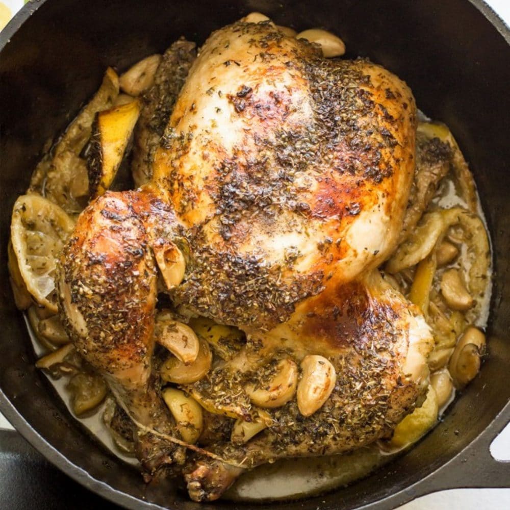 picture of lemon garlic whole roasted chicken in a dutch oven 