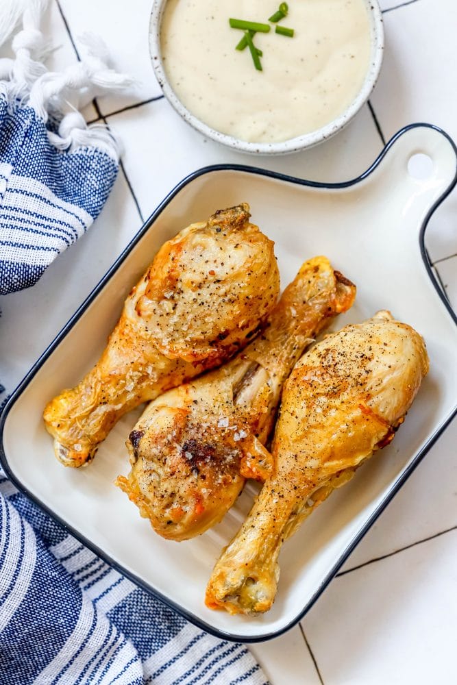 picture of three chicken drumsticks on a plate