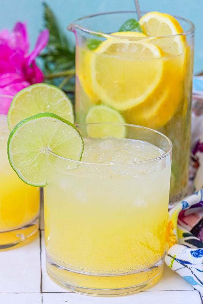 glass with yellow juice and lime on the rim
