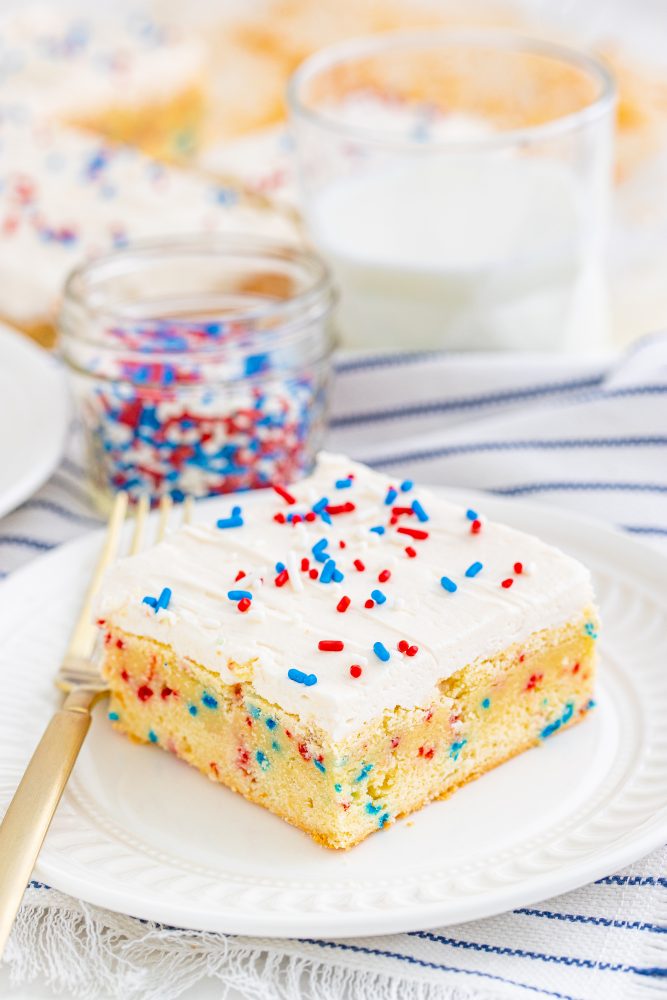  a vanilla bar with red and blue sprinkles in them and on frosting on top