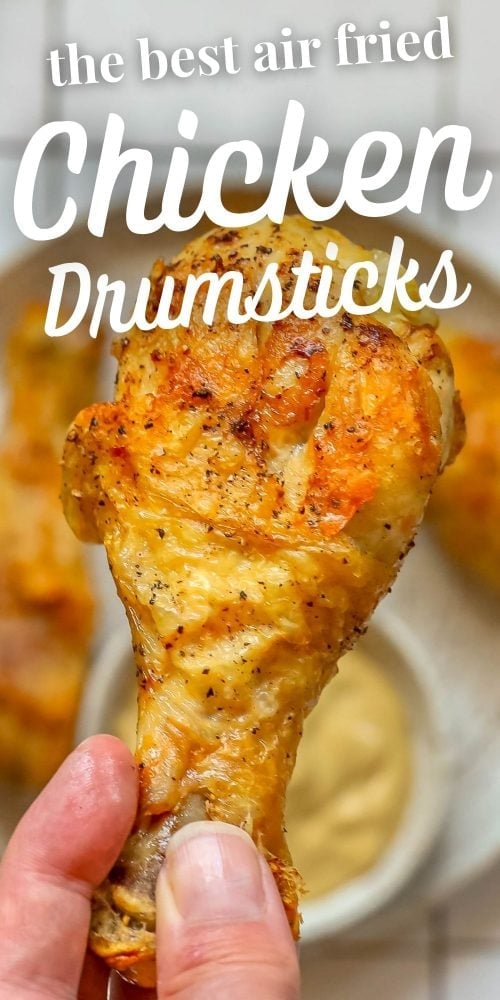 picture of a hand holding a chicken drumstick 