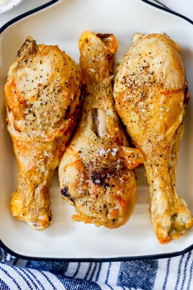 picture of three chicken drumsticks on a plate