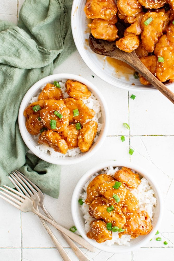 picture of sesame chicken in a bowl over rice