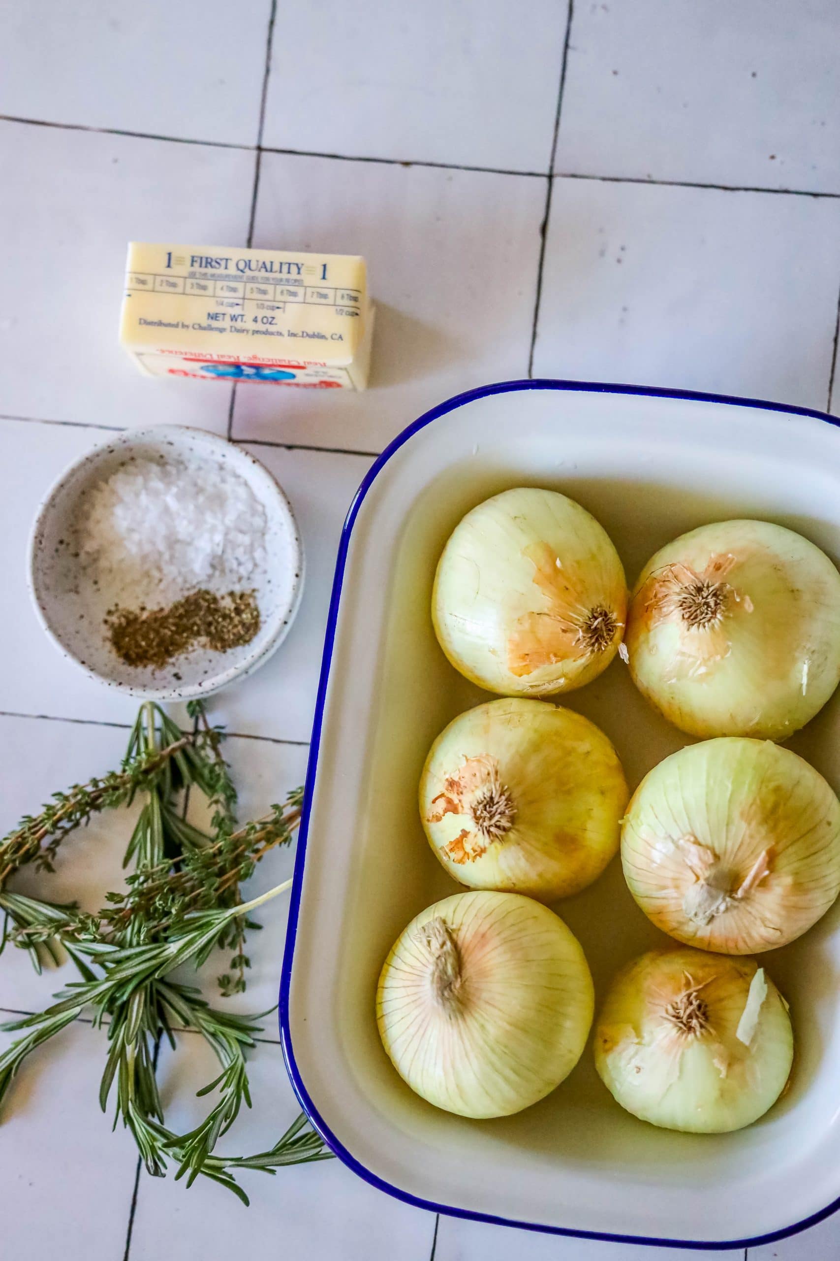 picture of onions, herbs, seasonings, and butter on a table