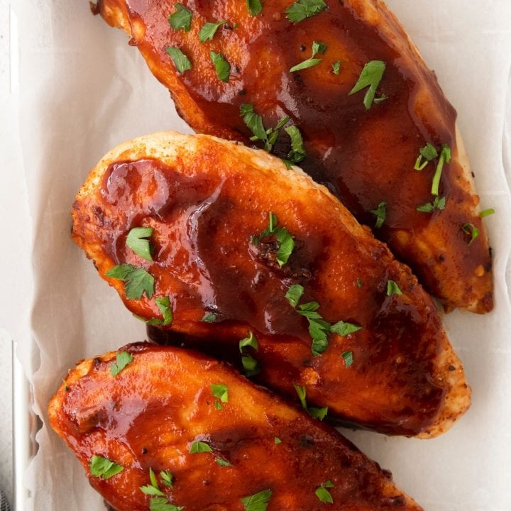 Air fried bbq chicken breasts on a baking sheet.
