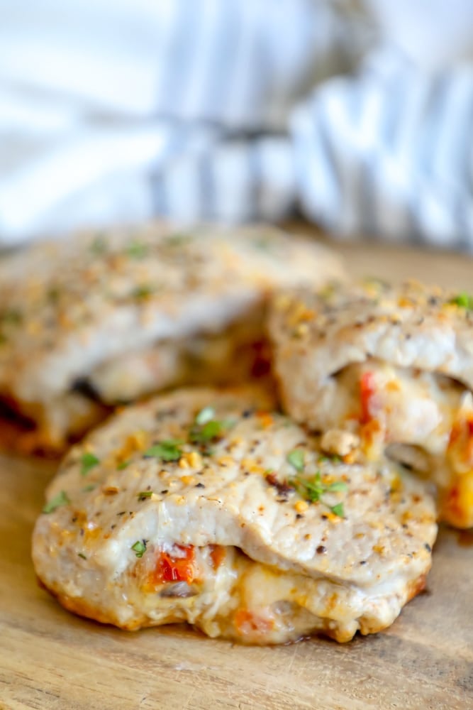 Picture of stuffed pork chops on a wooden cutting board