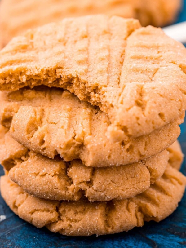 picture of peanut butter cookies stacked on a blue table