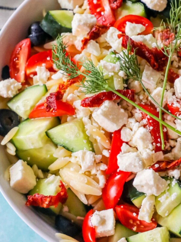 orzo, cucumbers, tomatoes, dill, feta, olives, in a bowl