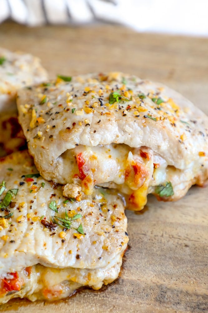 Picture of stuffed pork chops on a wooden cutting board