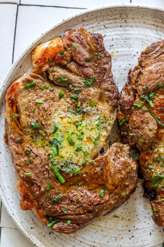 steak with chives and butter on it