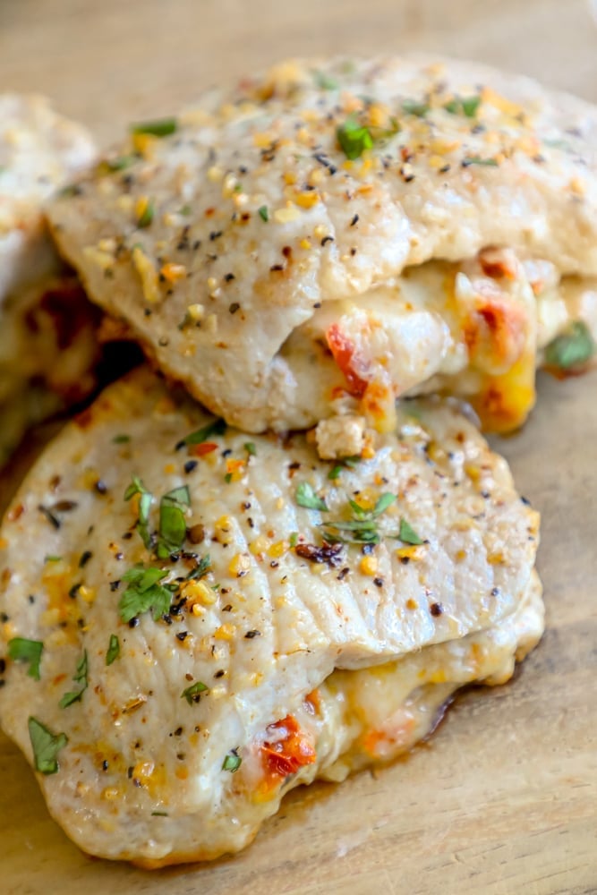 Picture of stuffed pork chops on a wooden cutting board